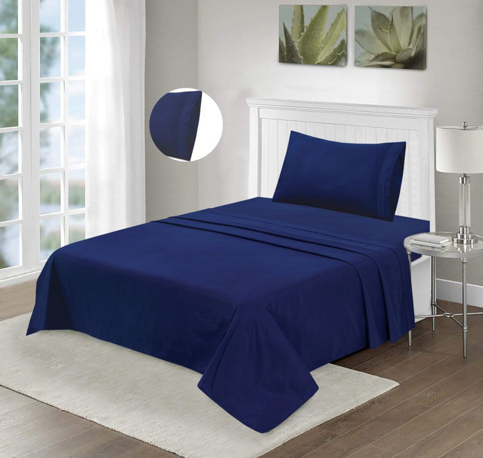 Navy microfiber bed sheet set with navy embroidery, styled on a bed